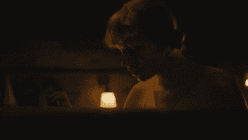 Taylor Swift opening a magical box in her "Cardigan" music video