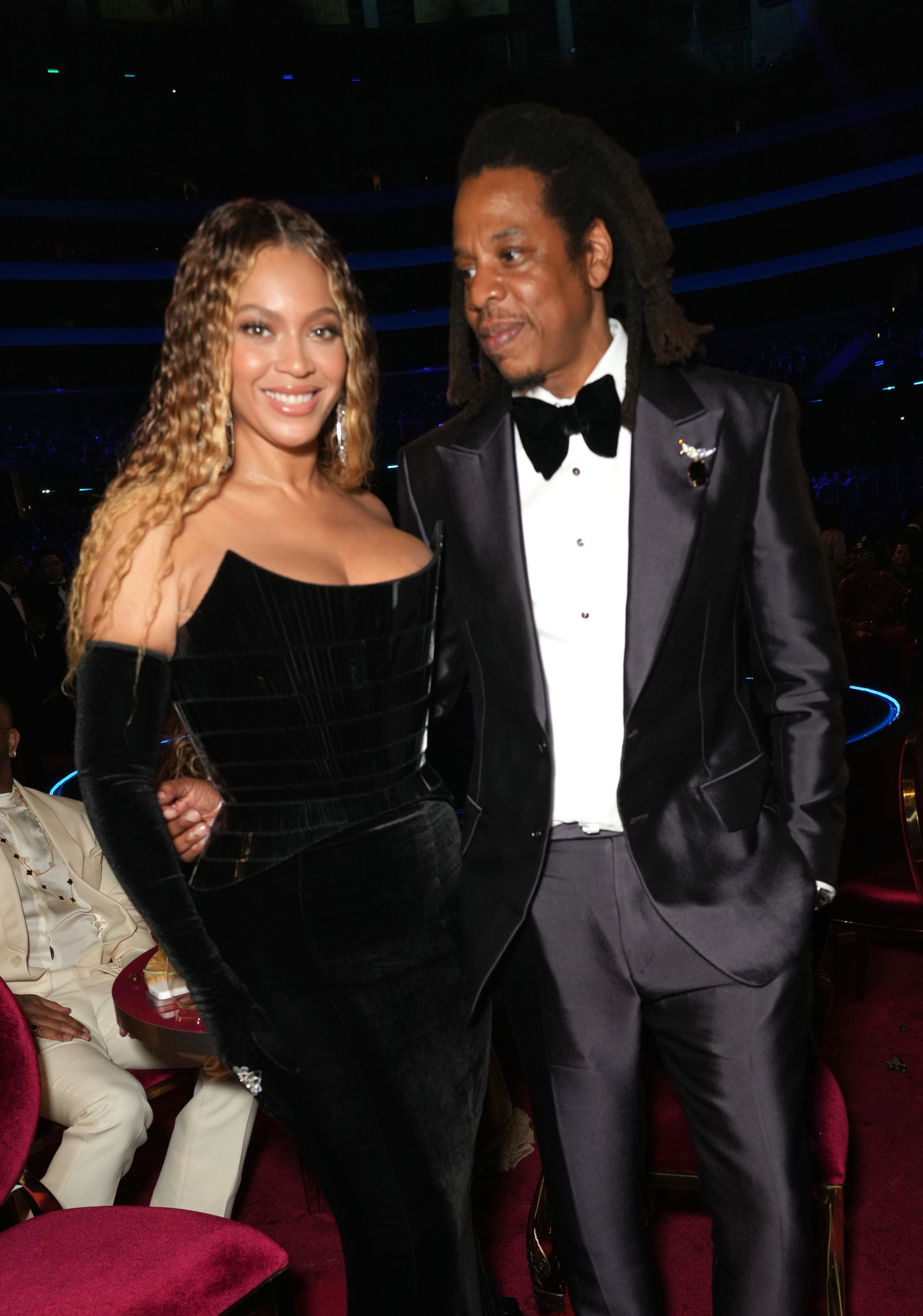 Jay-Z looking at a smiling Beyoncé