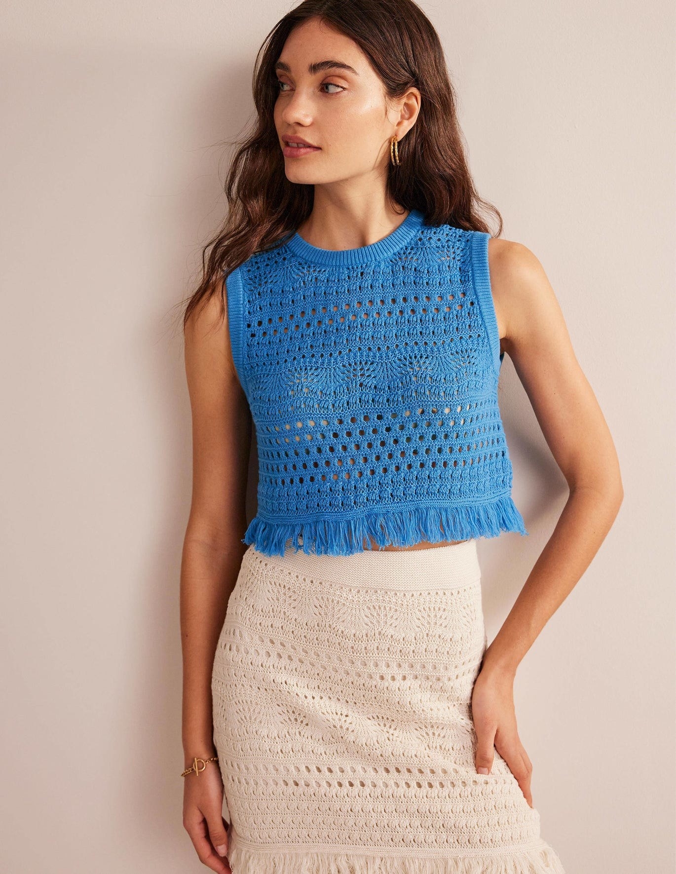 model in cropped bright blue crochet tank