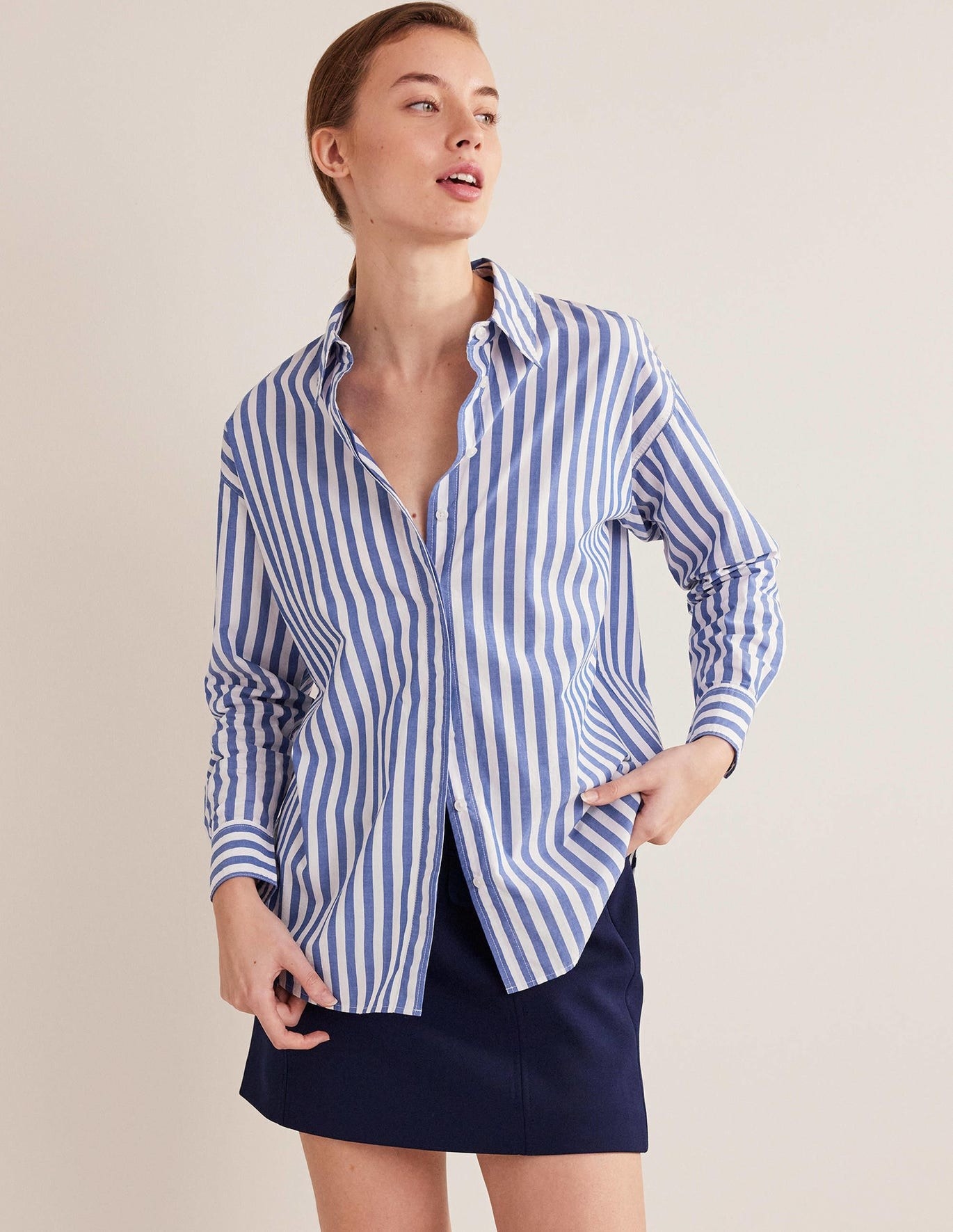 model in blue and white vertical stripe button-up long sleeve shirt