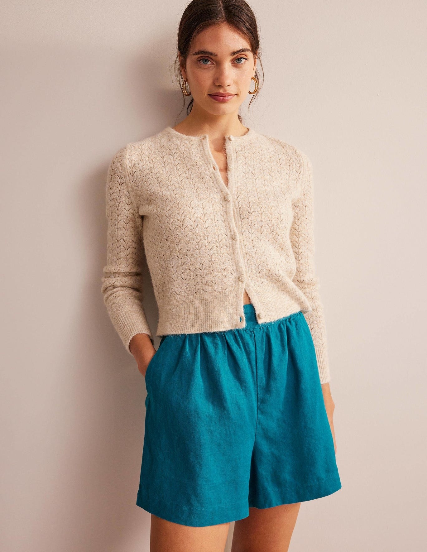 model in teal mid-thigh length wide linen shorts