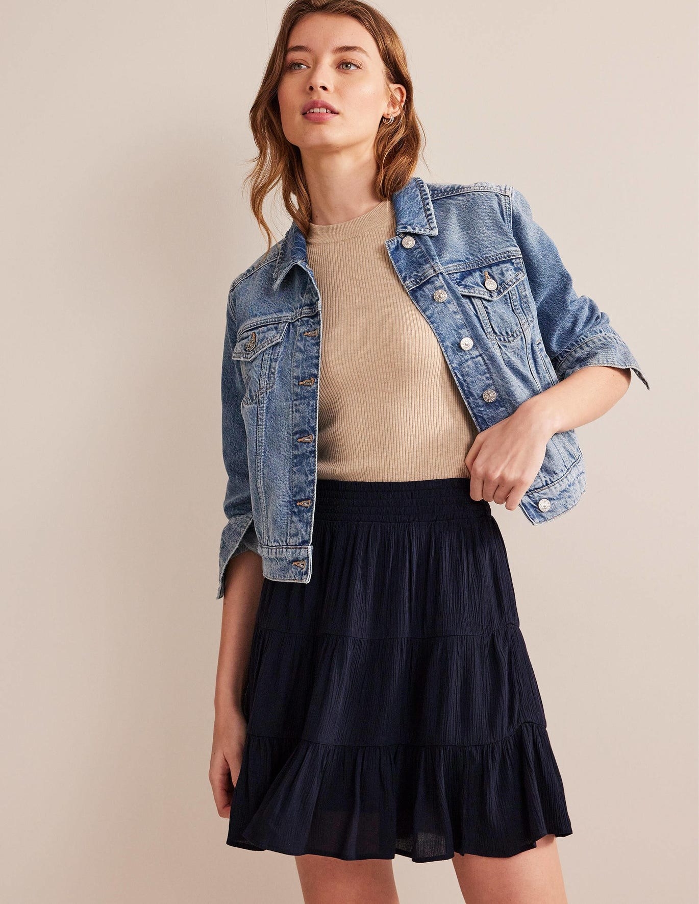 model in navy blue tiered mid-thigh length flowy skirt