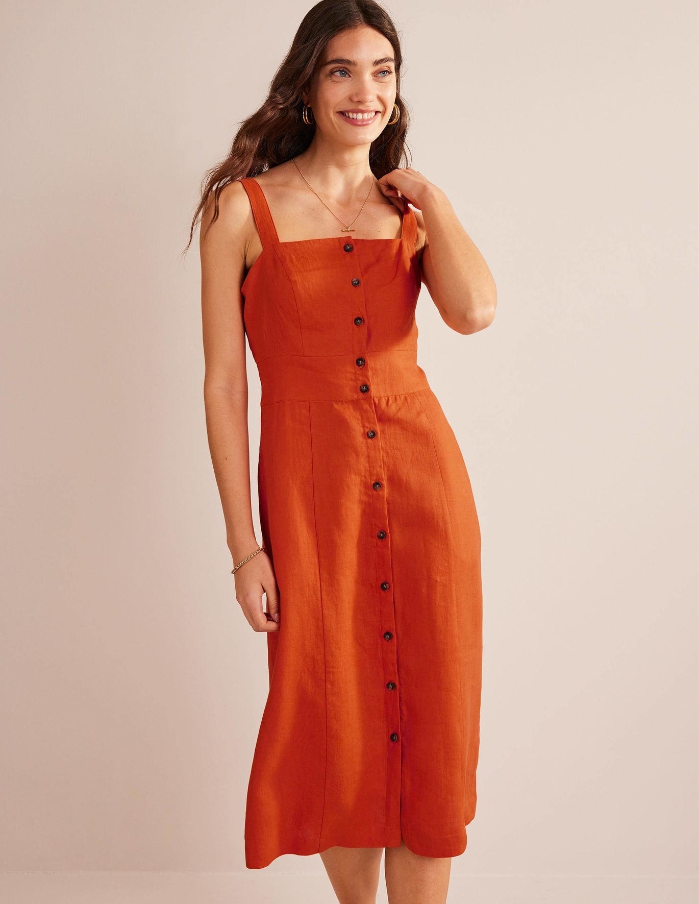 Model in orange button-up midi tank dress