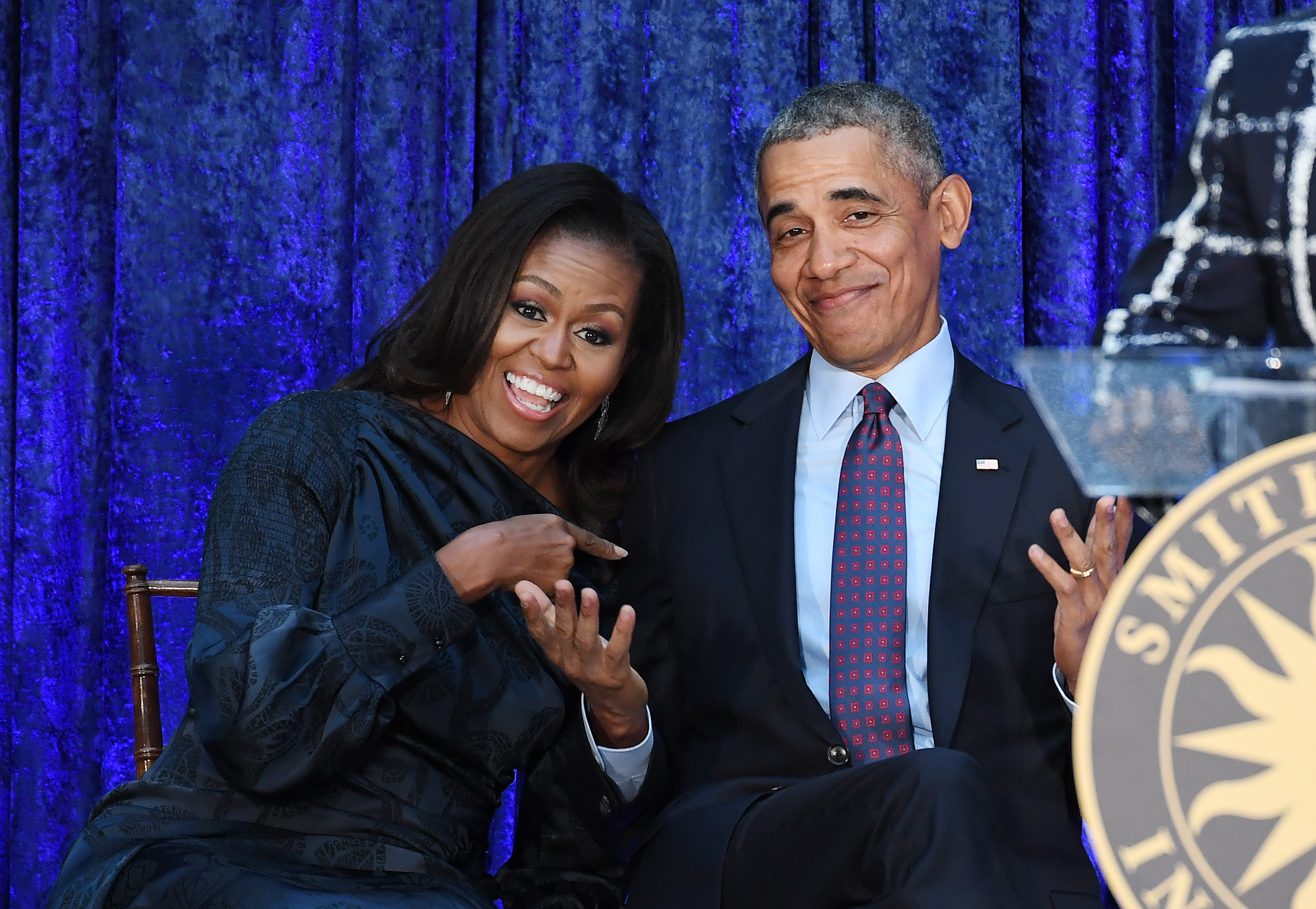 Michelle and Barack sitting and smiling together