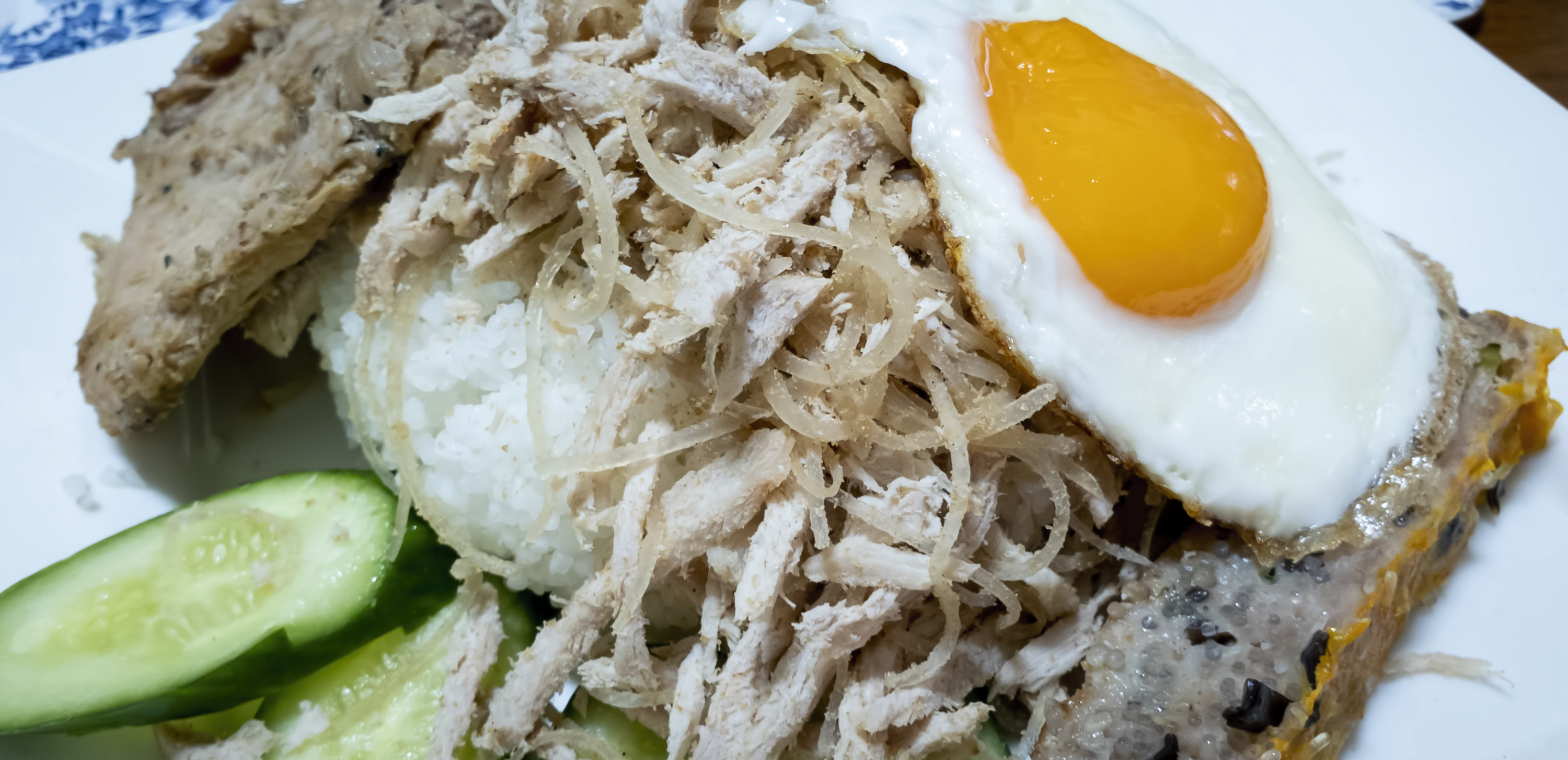 shredded meat and sunny side up egg over white rice