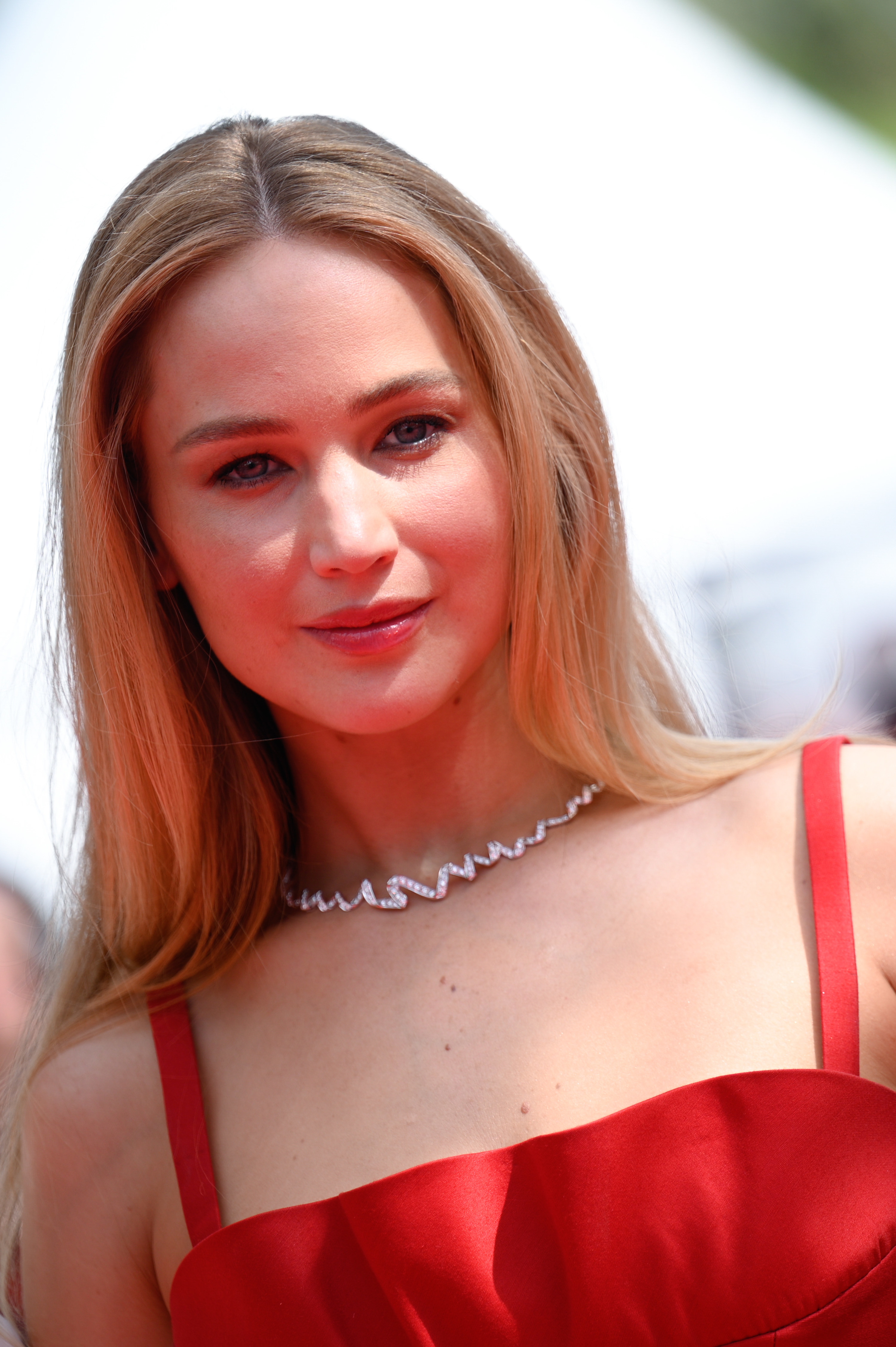 Close-up of JLaw on the red carpet in a spaghetti-strap red gown