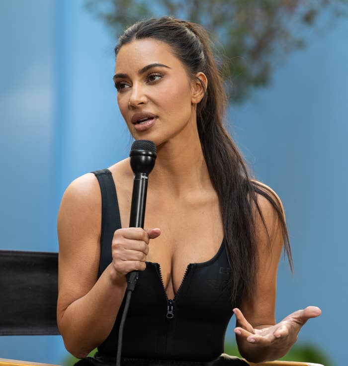 Kim holding a microphone
