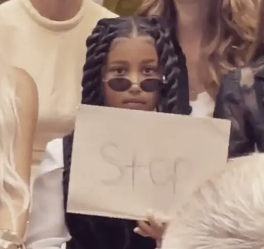 North looking at the camera and holding up a &quot;Stop&quot; sign
