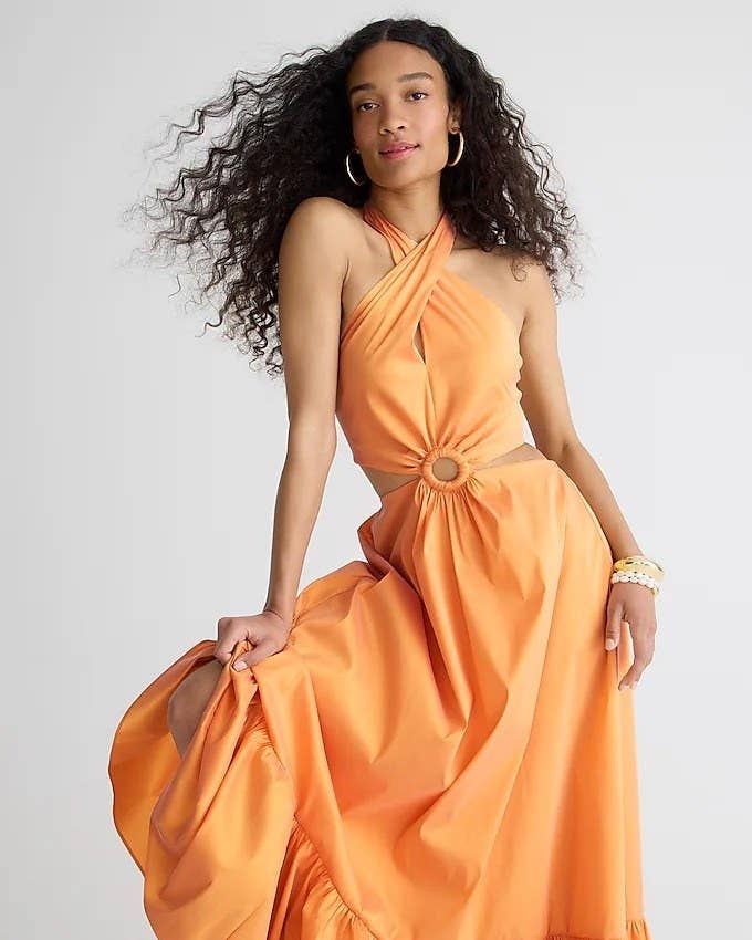 model wearing halter cut-out maxi dress in orange