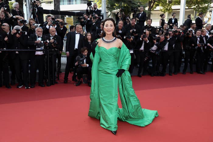 Michelle Yeoh wearing a gown with sleeves that extend down to the floor