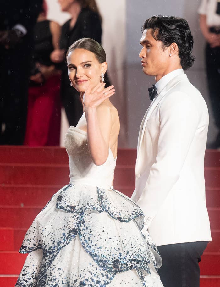 Natalie Portman waves to the camera while wearing a replica of the Christian Dior gown