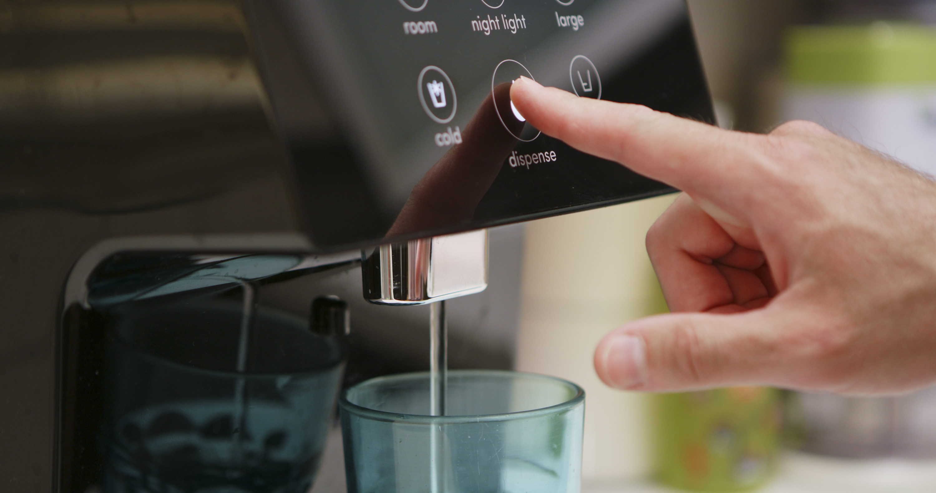 a person hitting the water button on a filter
