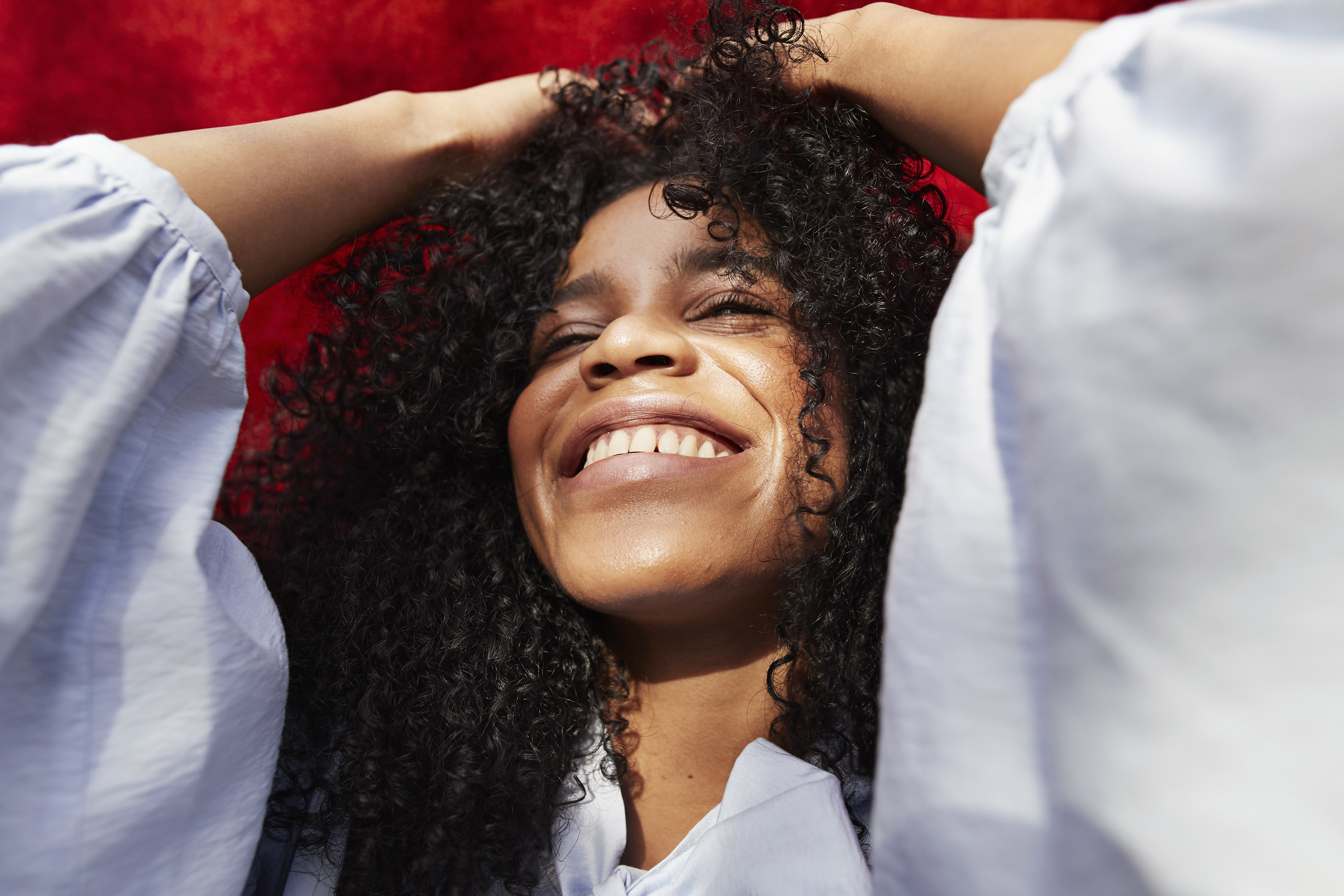 a woman with curly hair smiling