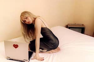 Sabrina on a bed with a laptop.
