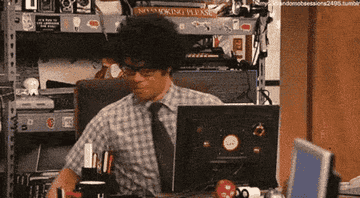 A man behind a computer picking up a popcorn box and saying 'go on&hellip;'