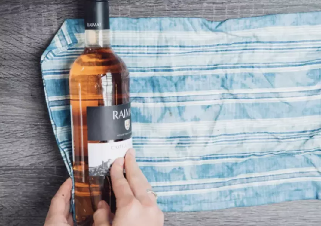 Wrapping a wine bottle in a wet dish towel.