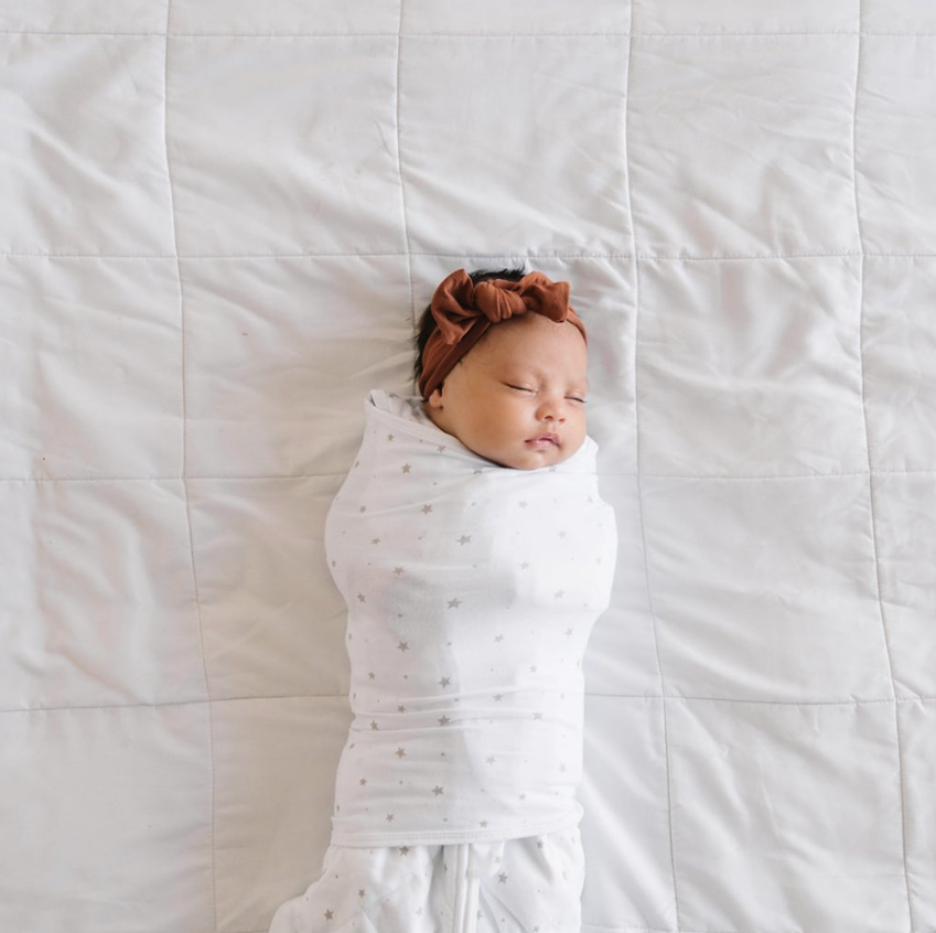 infant wrapped in swaddle