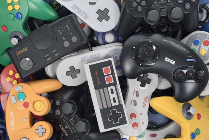 A pile of retro video game controllers shot from above.