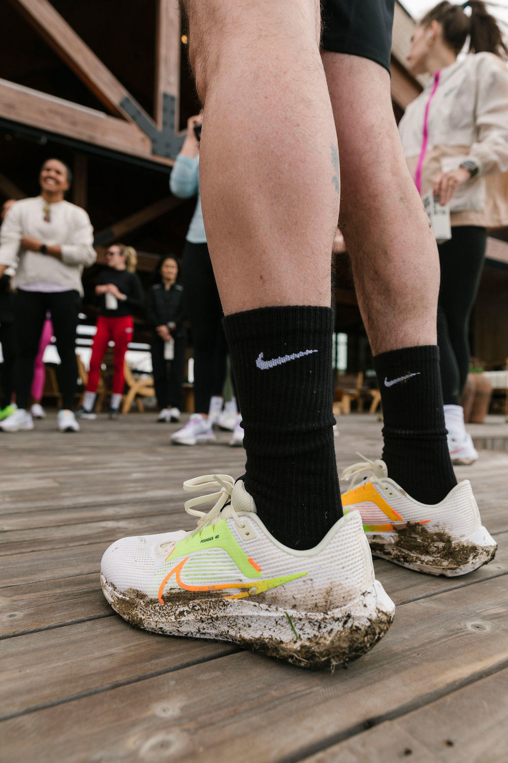 A runner at Camp Nike with muddy shoes after completing a run.