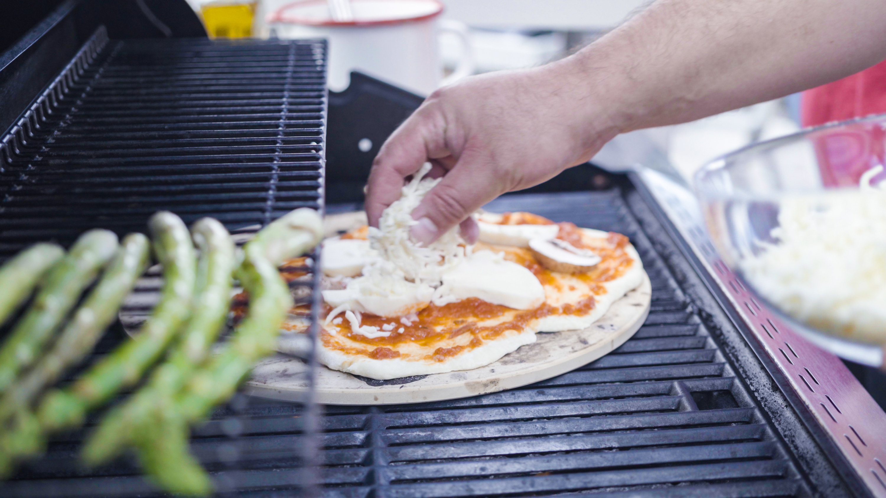 Grilling pizza on an outdoor bbq.