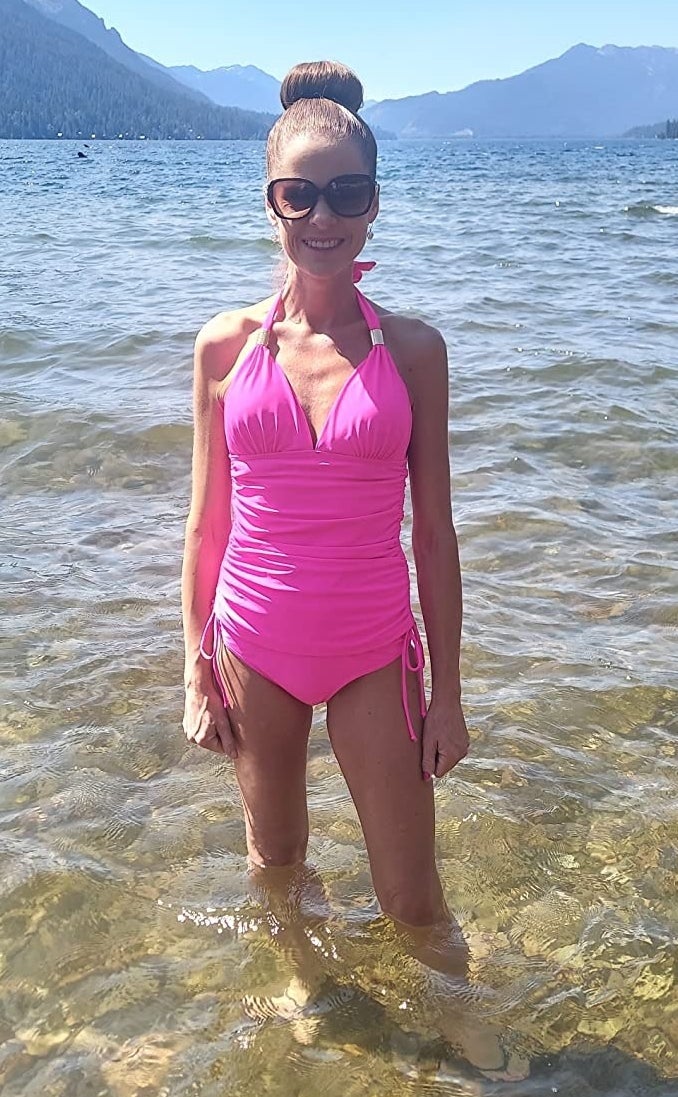 A reviewer in the hot pink swimsuit