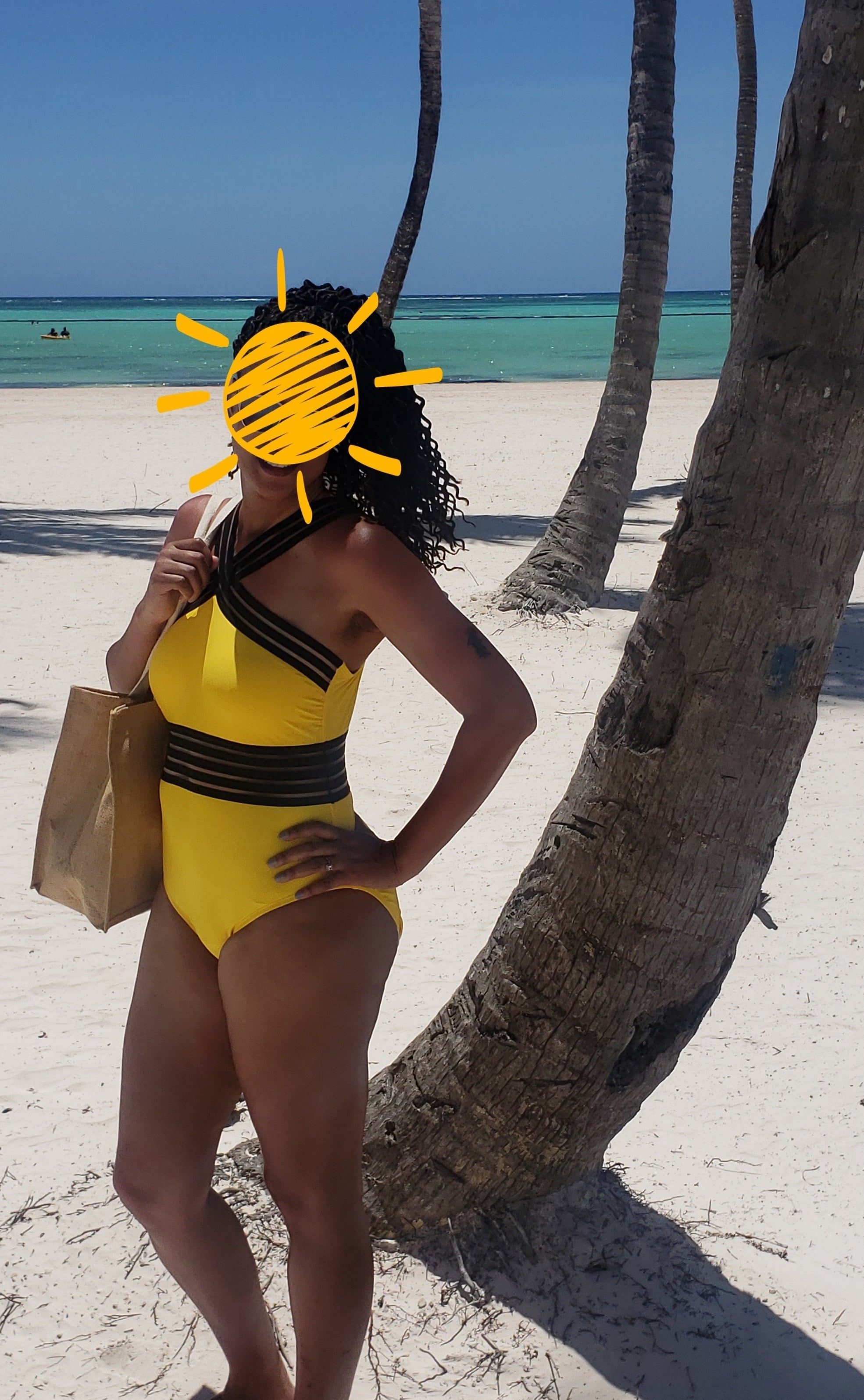 A reviewer in the black and yellow swimsuit