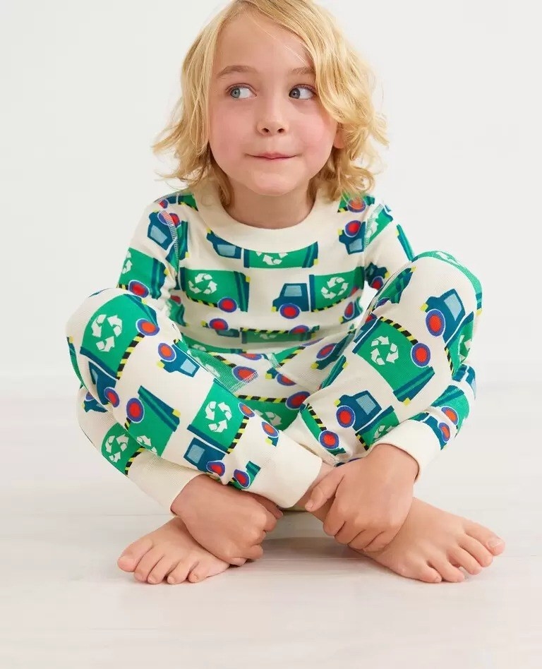 model wearing pajamas with illustrations of recycle trucks all over