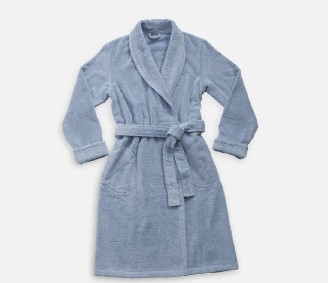 A blue Brooklinen robe with a white background