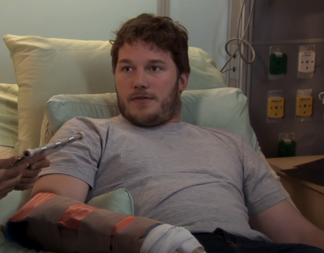chris in a hospital bed as andy dwyer