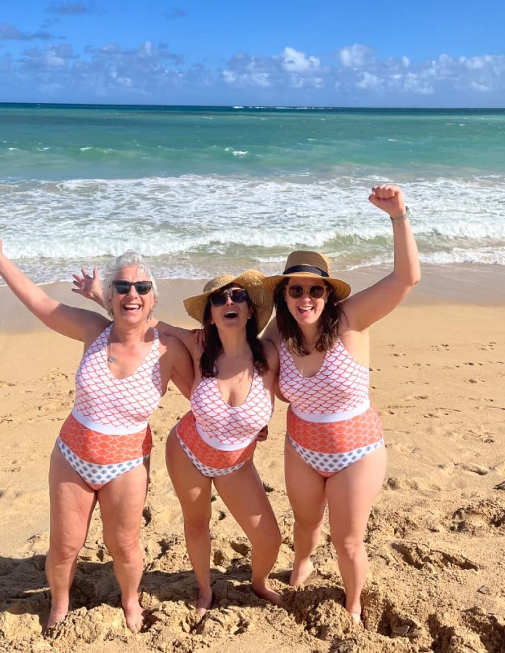 Three reviewers wearing the same one piece swimsuit