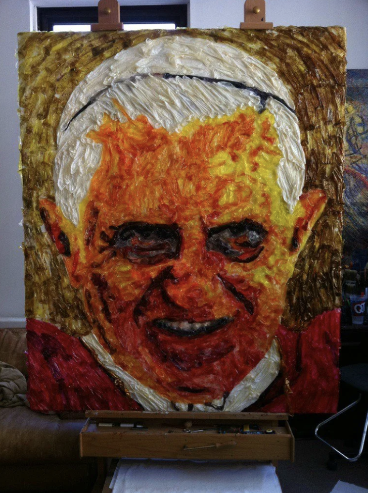The pope&#x27;s smiling face made out of melted condoms that look like paint