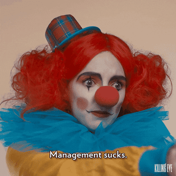 woman in clown costume saying &quot;management sucks&quot;