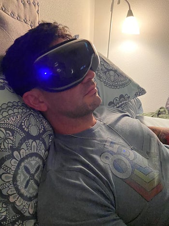 a reviewer wearing a massaging eye mask