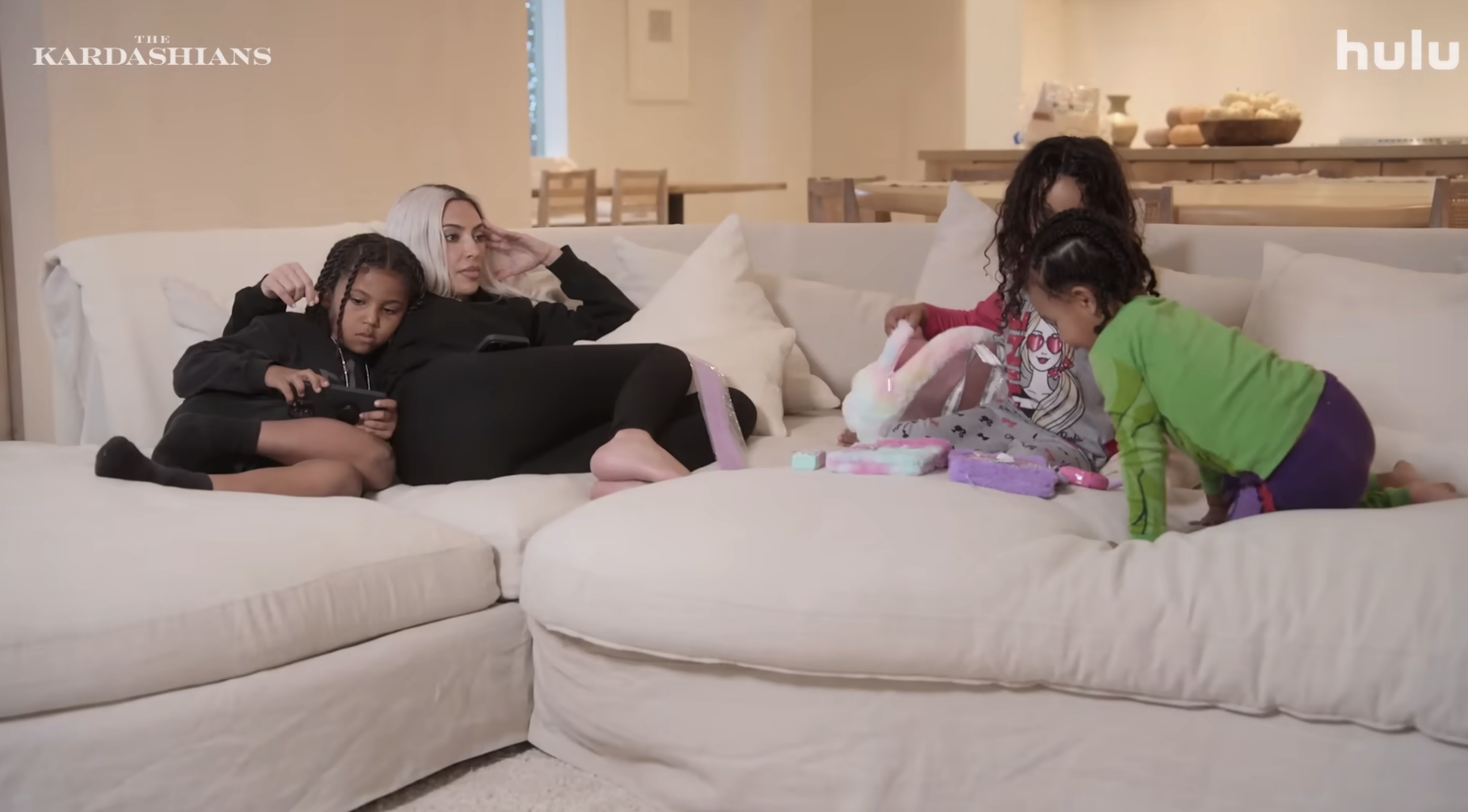 Kim with three of her children on a couch