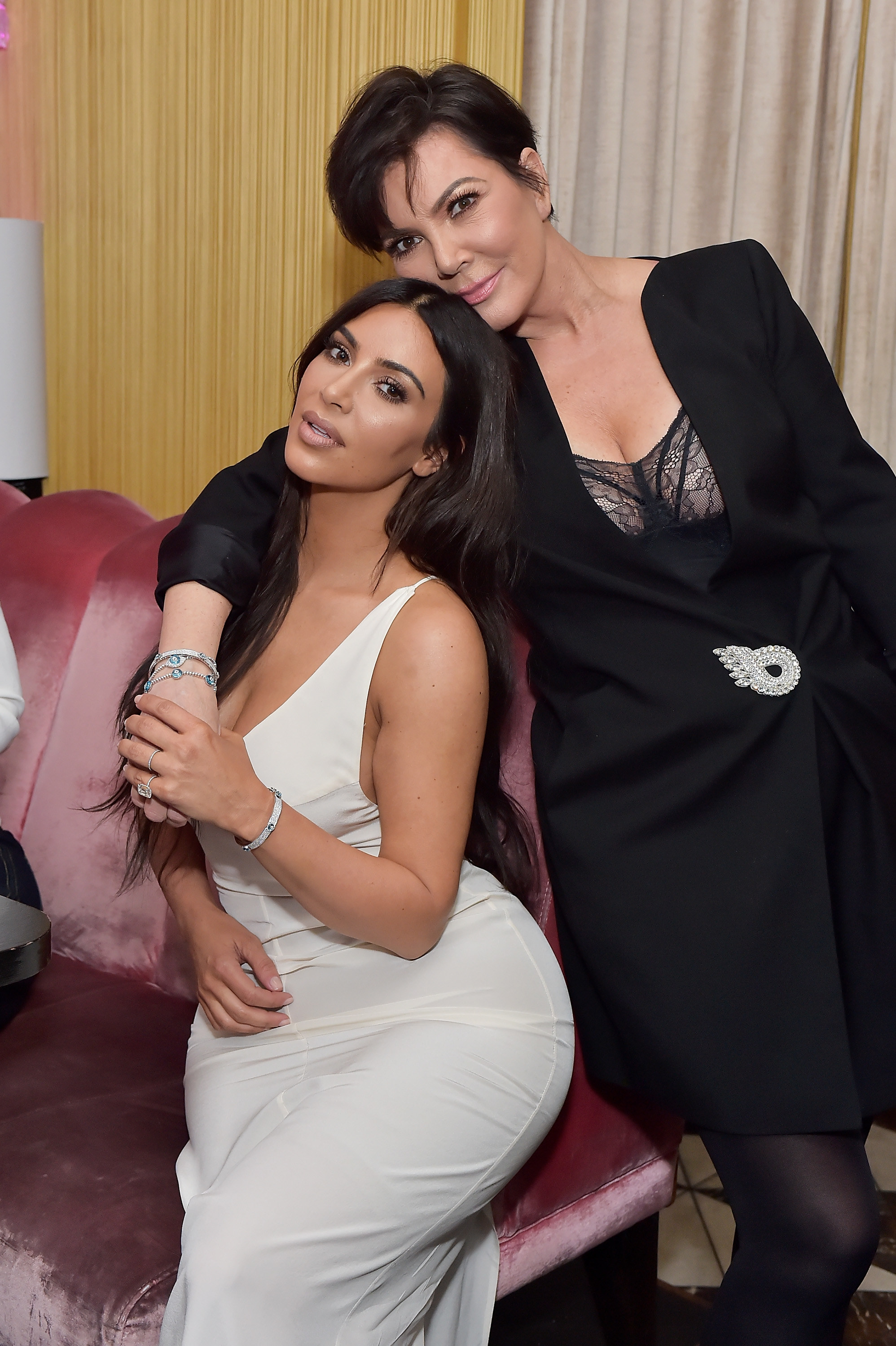 Kris with her arm around a seated Kim