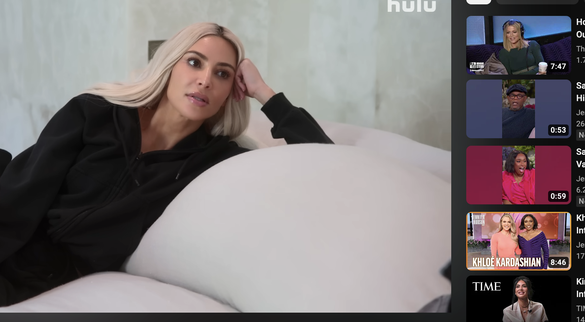 Kim leaning on couch pillows