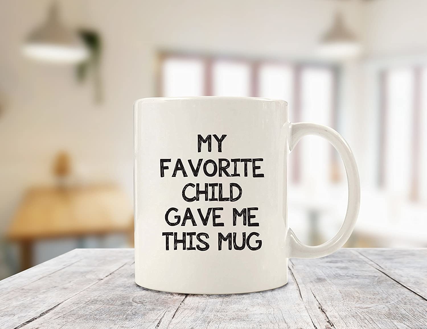 a white mug that says &quot;my favorite child gave me this mug&quot; on it