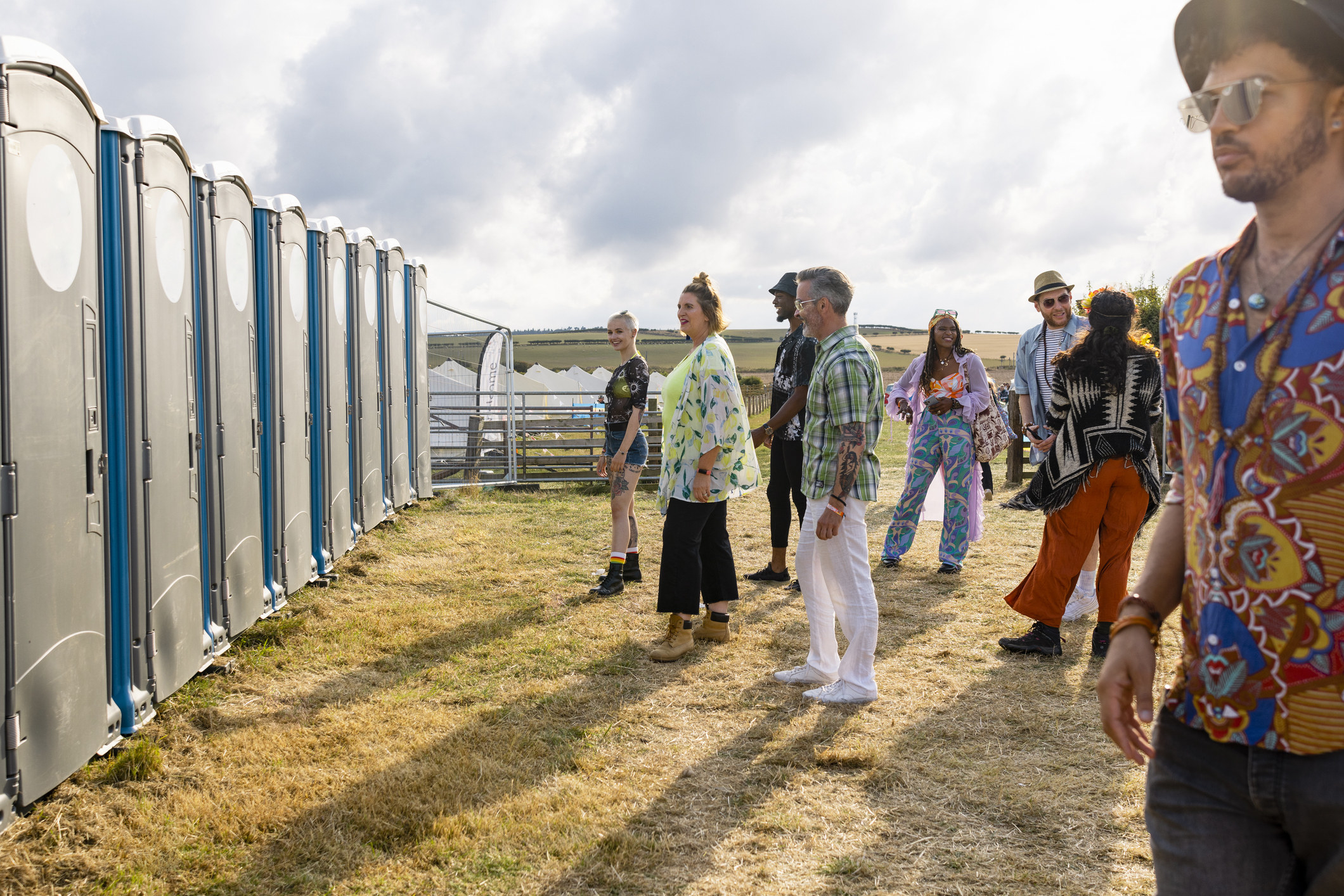 People waiting to use the bathroom at a concert