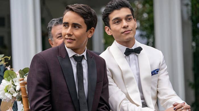 Victor and Rahim sitting next to each other at a wedding