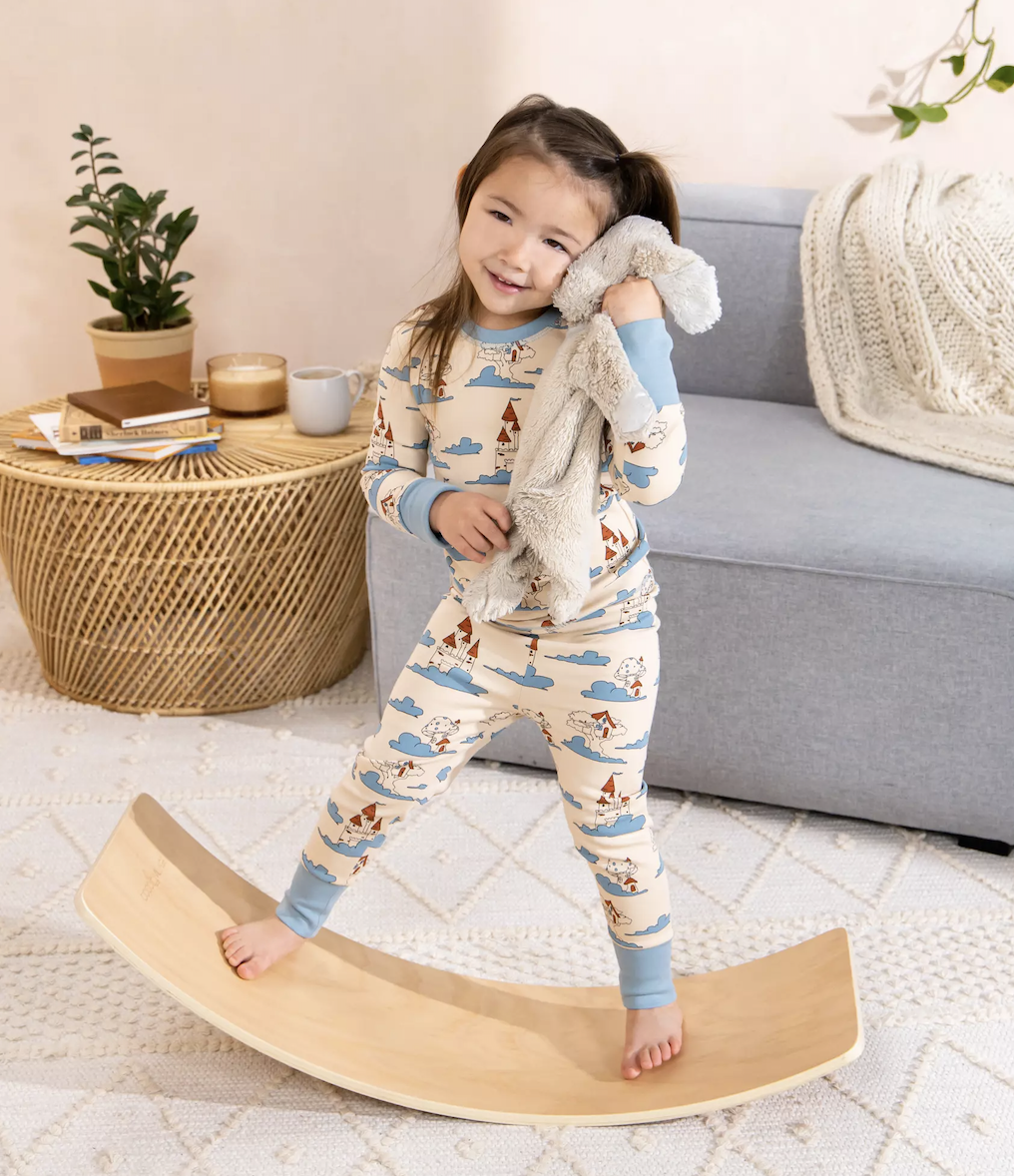 child balancing on curved board