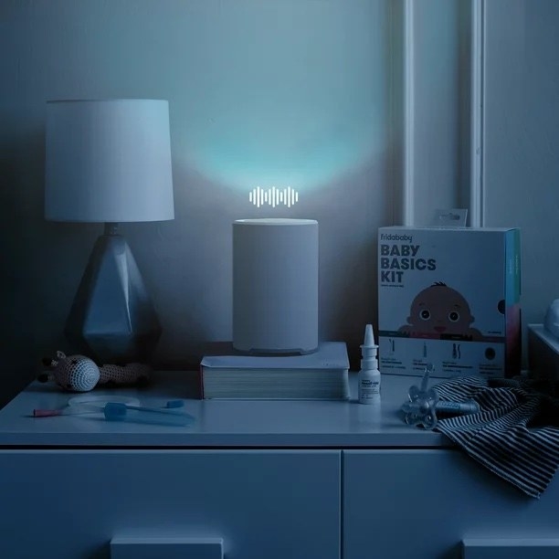 A blue room with a light and baby supplies
