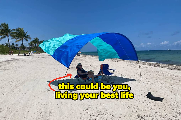 a reviewer sitting under the blue and teal sheet flying in the wind "this could be you, living your best life"
