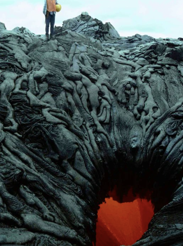 a person standing over a lava pit