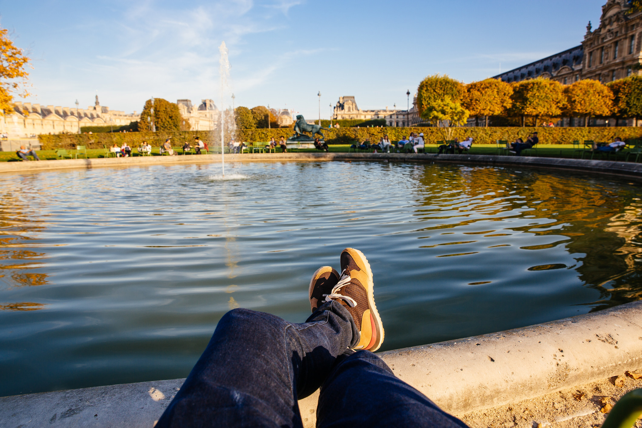 Personal perspective of someone resting by the fountain in the Tuileries Garden in Paris