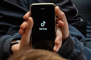 In this photo illustration, a boy looks at the TikTok app