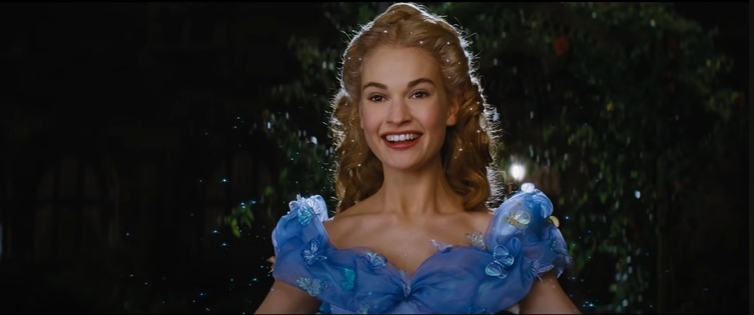 Cinderella, wearing her iconic blue gown with sheer sleeves and sparkles