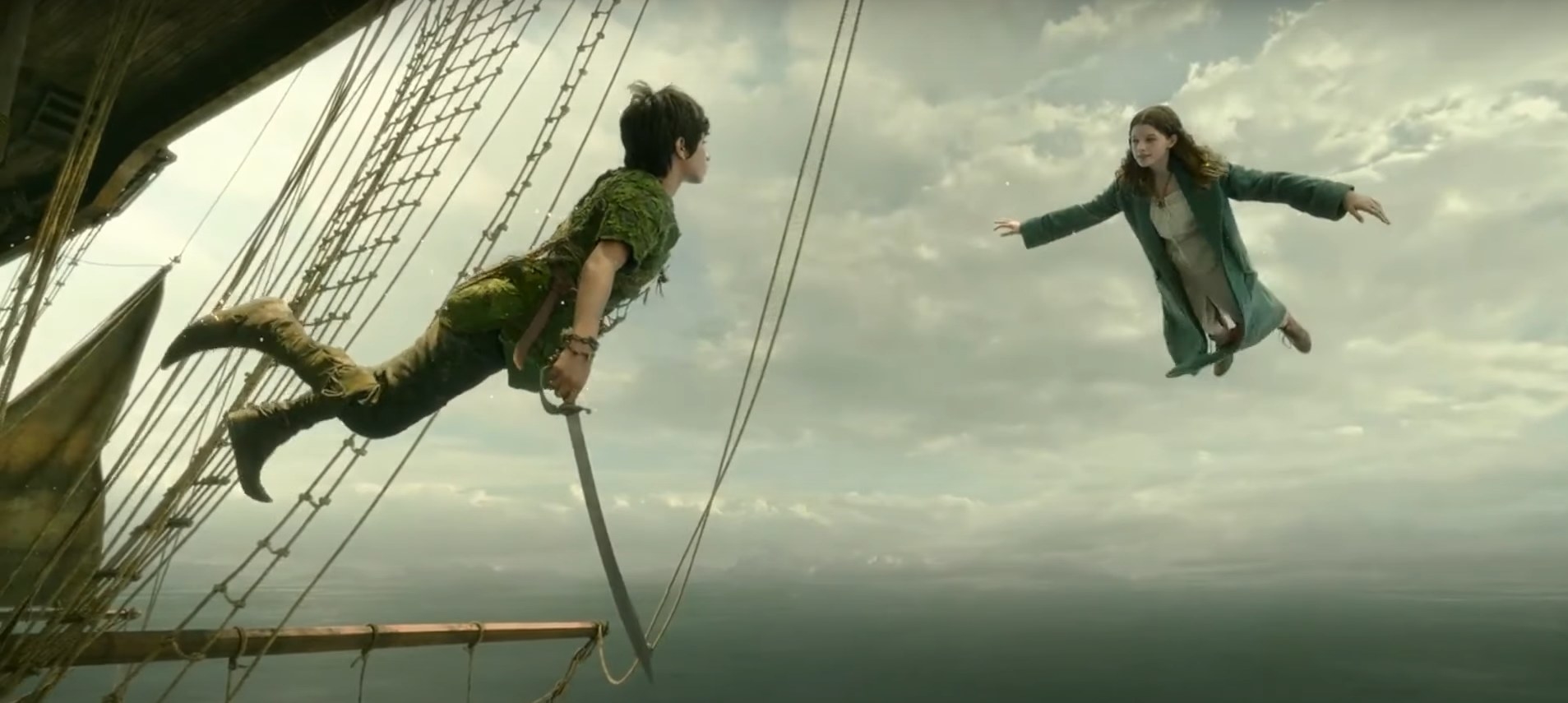 Peter Pan and Wendy flying next to a pirate ship in the sky