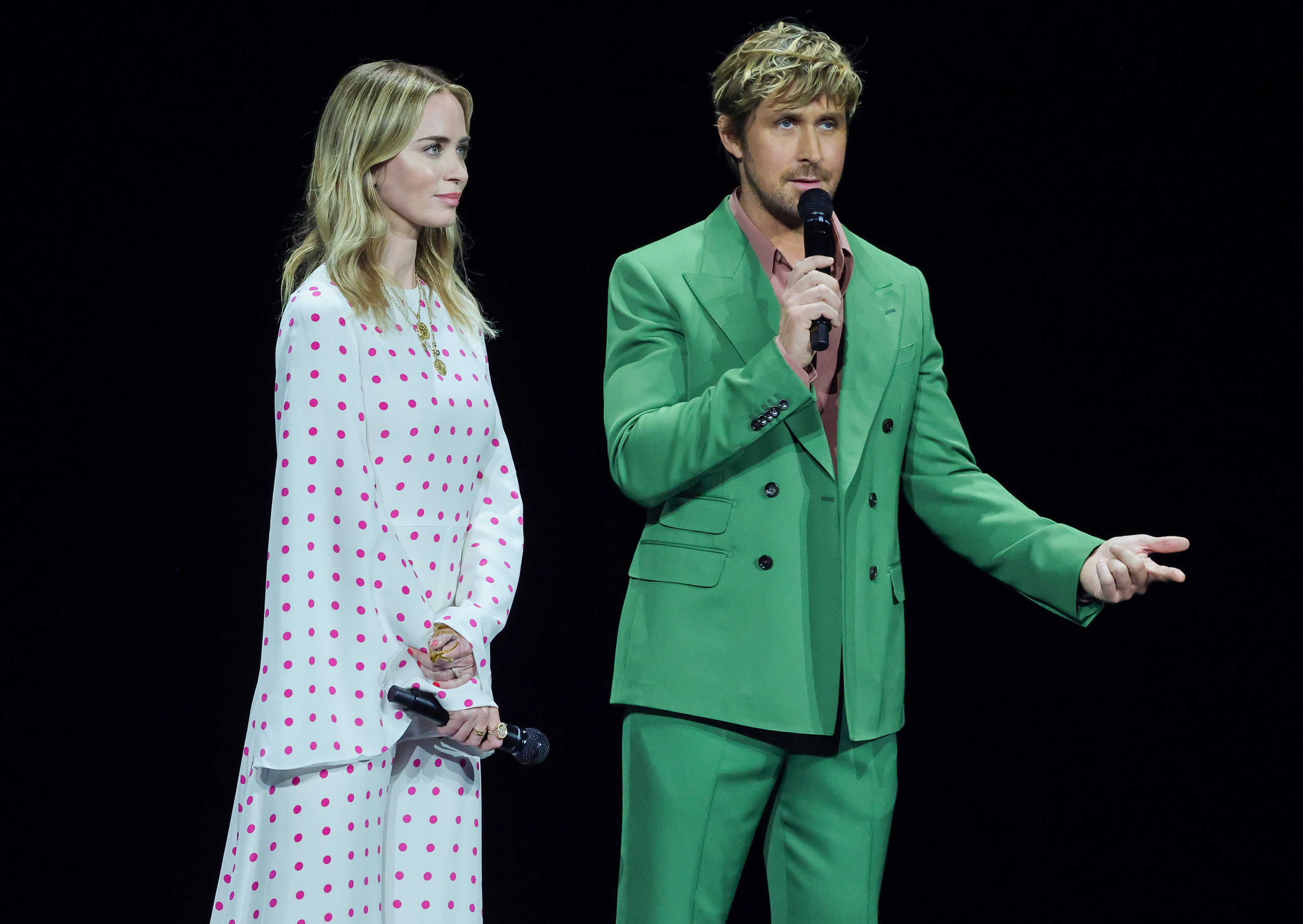 Ryan in a green suit standing next to Emily Blunt