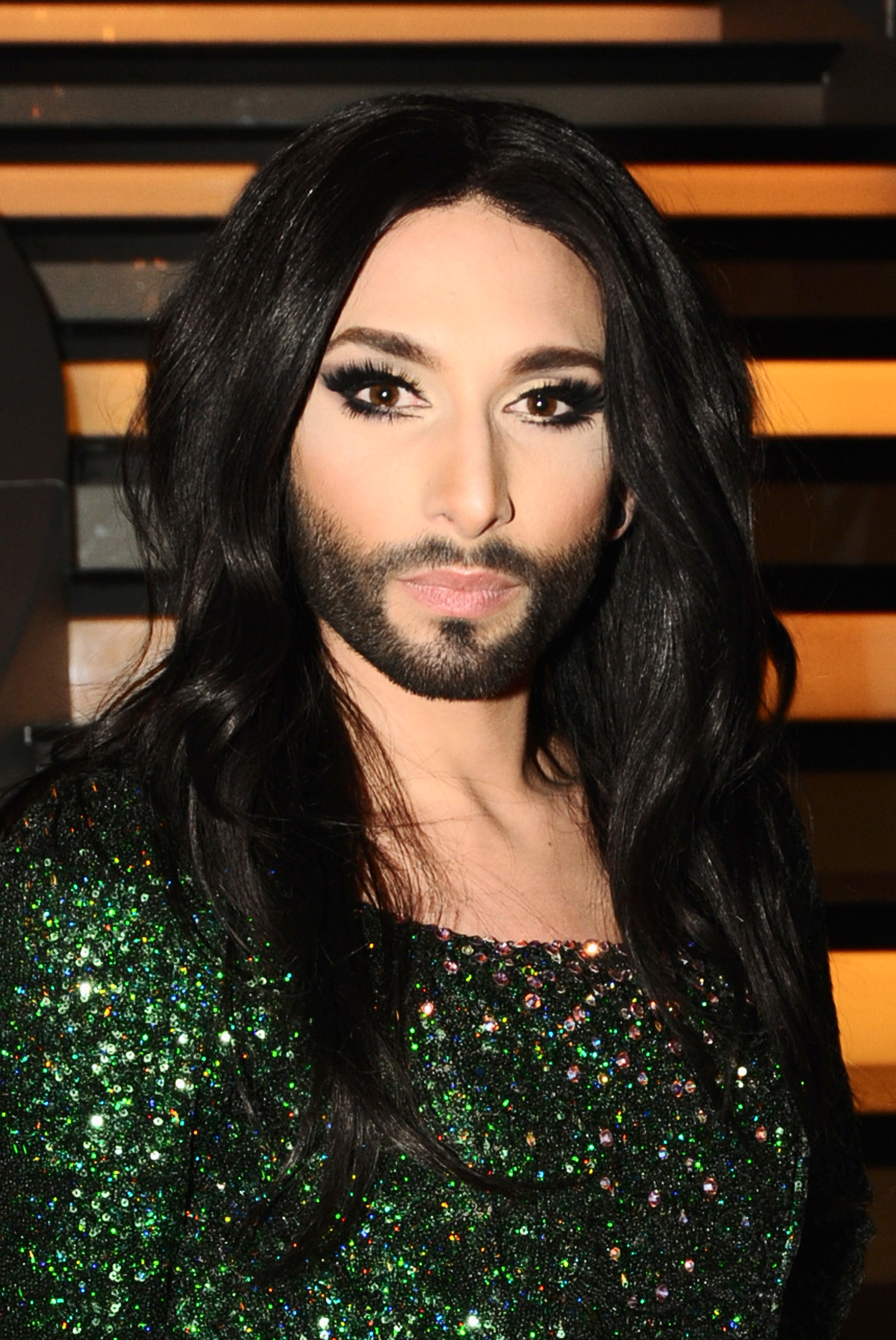 Close-up of Conchita Wurst, wearing a sparkly green dress