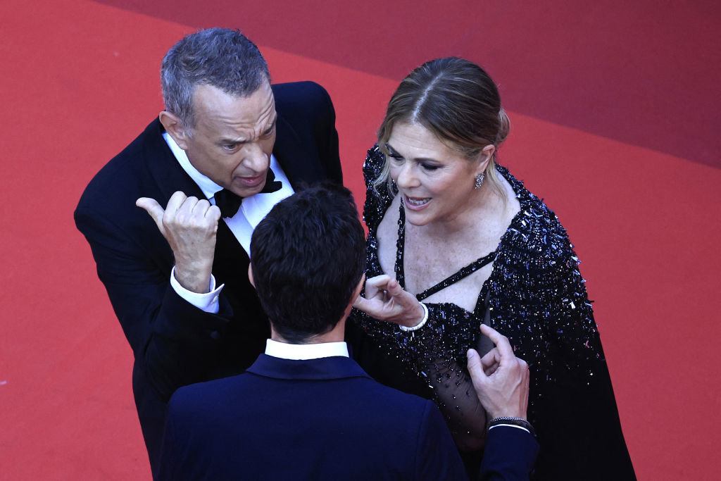 Tom Hanks and Rita Wilson speaking with someone